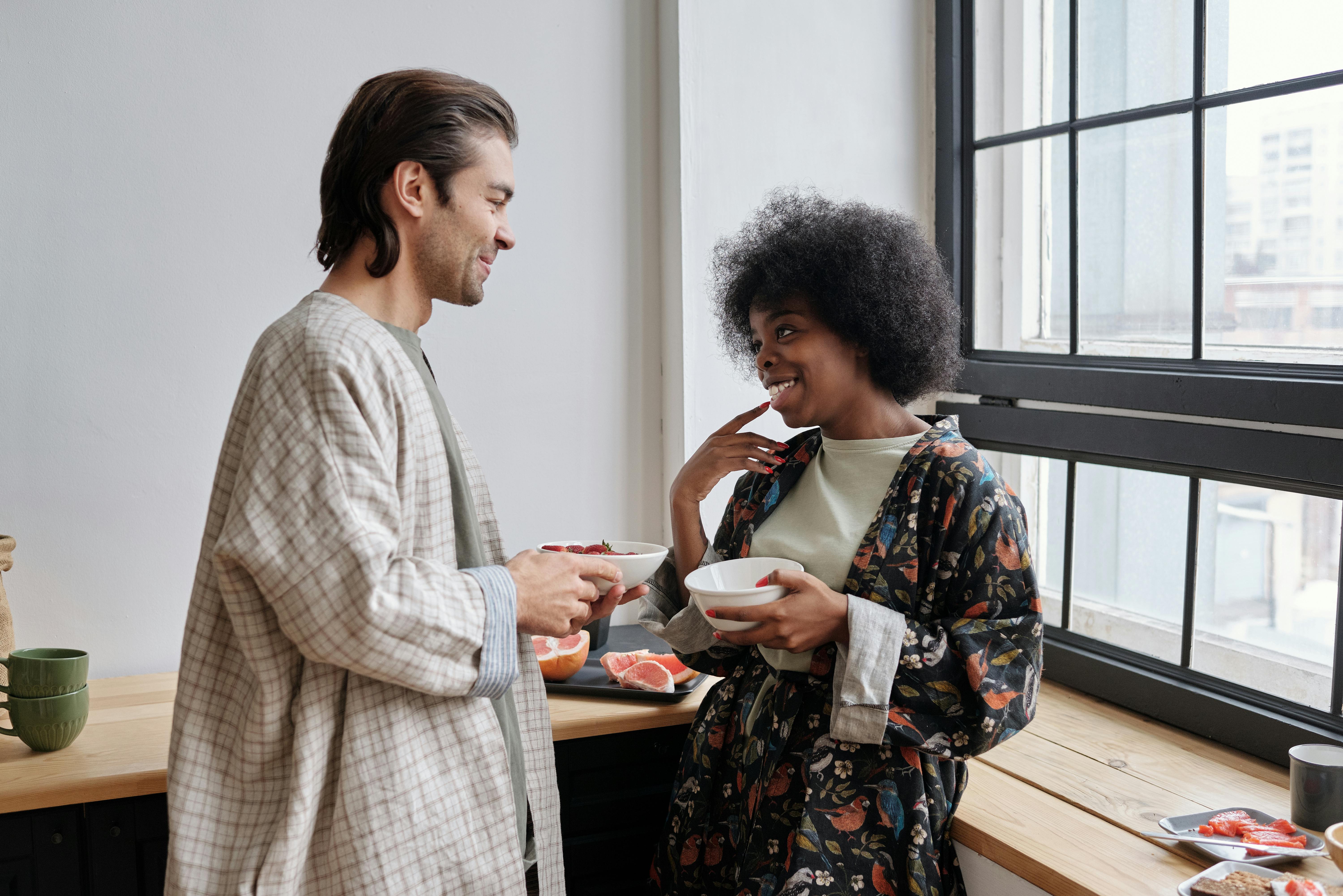 Man in white robe talking to a woman